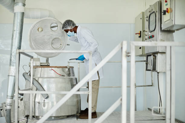 istock Male Technician Looking inside of Tank while Inspecting Production Process at Pharmaceutical Factory 2176475719