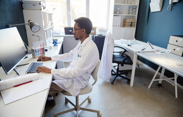 istock Male Medical Scientist Using Computer while Studying Chemicals in Laboratory 2176475734
