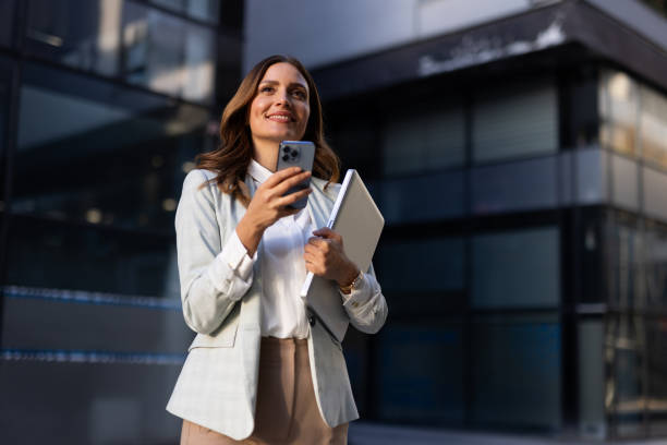 istock Professional woman checking her notifications in the city center 2176476308