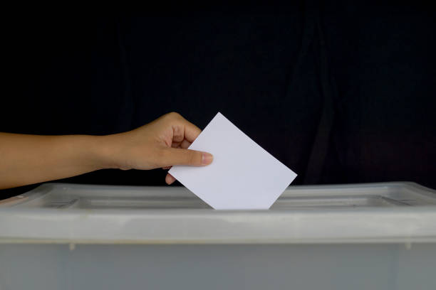 istock Hand drops a ballot into a box. Soft and selective focus. In the concept of voting system, voting, election, Members of the House of Representatives vote. 2176477064