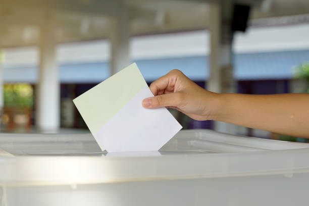 istock Hand drops a ballot into a box. Soft and selective focus. In the concept of voting system, voting, election, Members of the House of Representatives vote. 2176477083