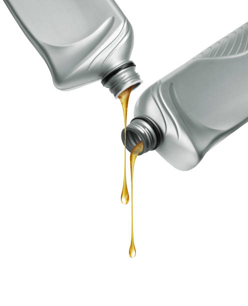 istock Stretched drops of oily liquid dripping from two gray plastic bottles 2176478640