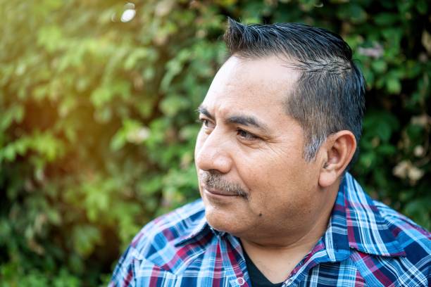 istock Smiling hispanic mature man posing looking away at his home backyard 2176479188