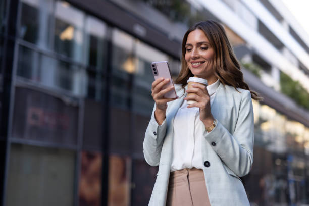 istock Stylish businesswoman using her phone while navigating the city 2176480243