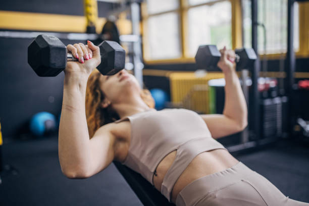 istock Woman on incline bench performing dumbbell exercise. 2176481060