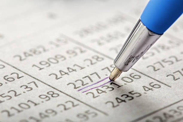 Checking the value of securities. Pencil, share listing and checking financial chart. Concept of banking, financial report and financial audit.