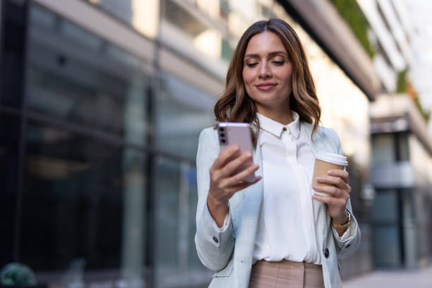 istock Stylish businesswoman using her phone while navigating the city 2176482941