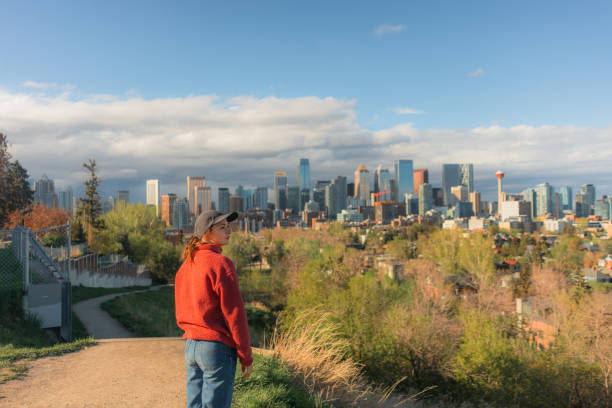 istock Woman looking at  Calgary cityscape from park 2176486231