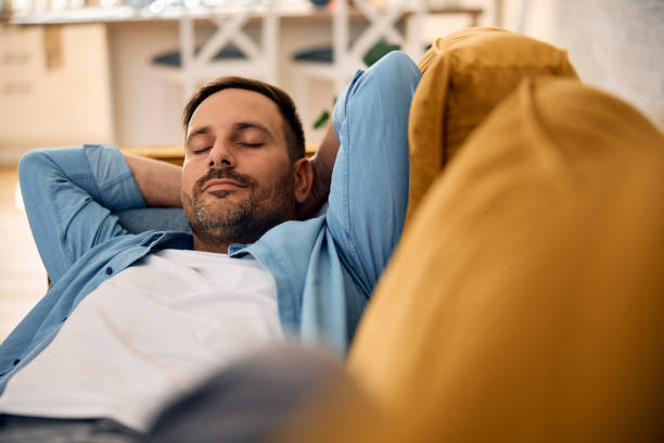 istock Relaxed man napping on the sofa at home. 2176488562