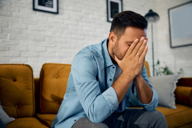 istock Depressed man sitting alone at home. 2176488656