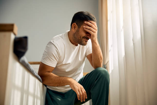 istock Smiling man holding hand on his face in the bedroom. 2176489946