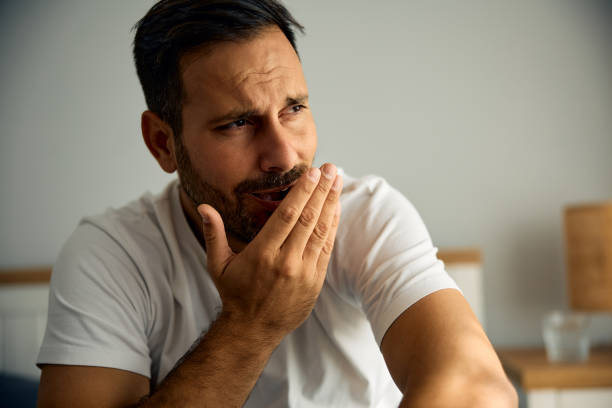 istock Sleepy man yawning in the morning. 2176490121