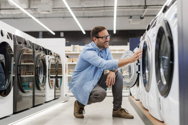 istock Man shopping for a washing machine in appliance store 2176492044