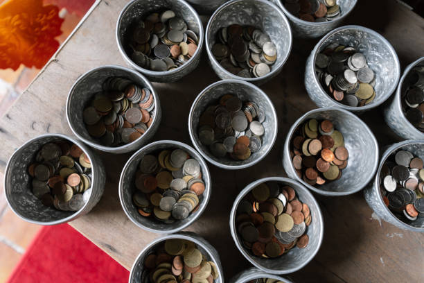 Coins in bowls, ready for donation at a Buddhist temple.
