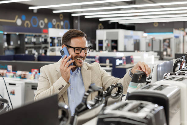 istock Man shopping for kitchen appliances while talking on the phone 2176492296