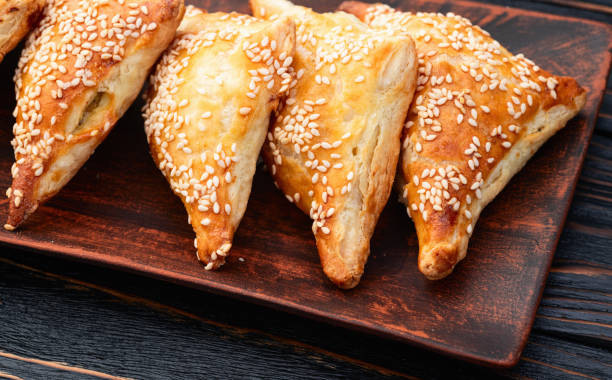 istock Homemade triangle puff pastry with meat on rustic background . Samosa 2176496041