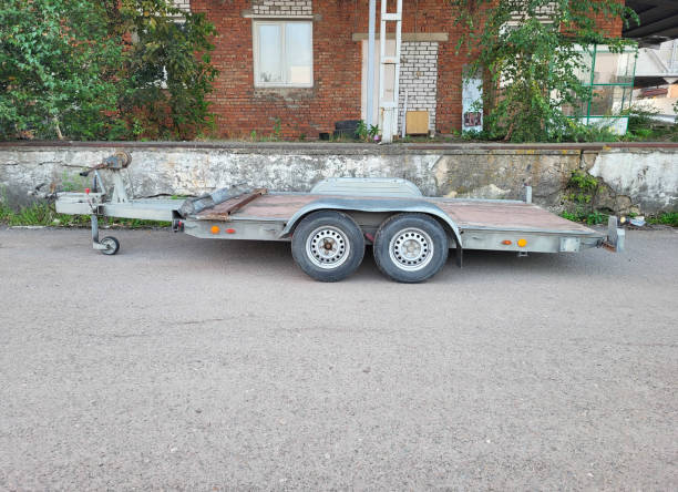 istock A small open empty cargo trailer is parked in the yard. 2176500101