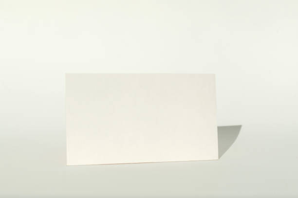 istock White blank business card on brown paper background with soft shadow. 2176501550