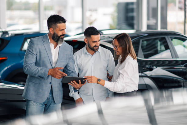 istock Showroom interaction showcasing car details on digital device. 2176505370