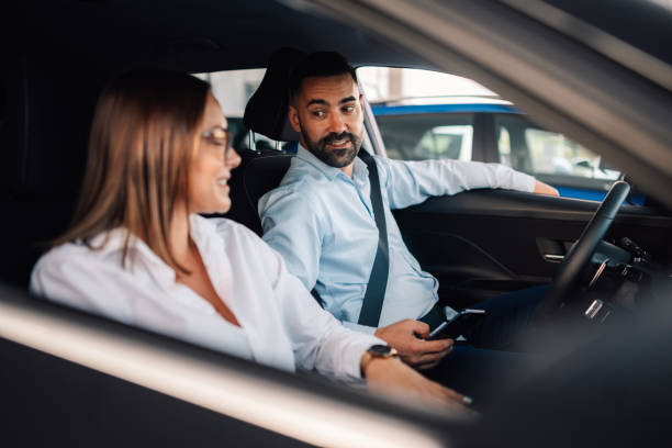istock Man and woman conversing inside car in relaxed atmosphere 2176505386