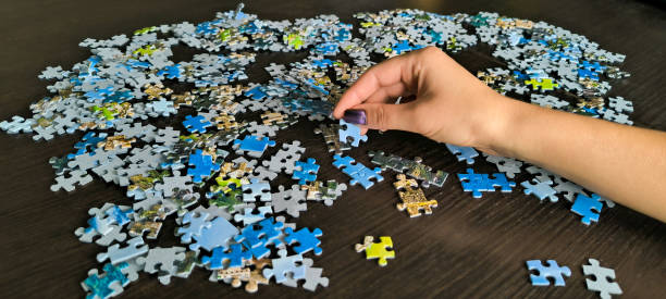 istock Woman assembling a mosaic. Assembling puzzles. A hobby for the soul. Development of fine motor skills of hands. Fun games for the whole family. 2176507901