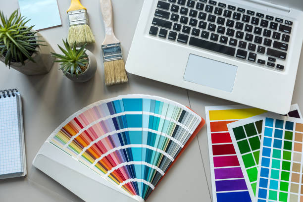 istock Office desk table with colour swatches book computer laptop, empty notepad pen 2176508455