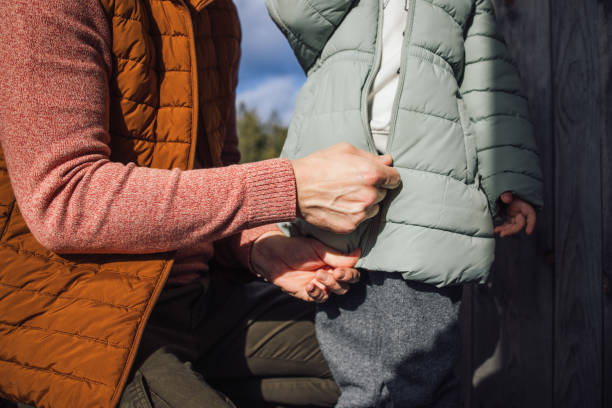 Parent Zipping Child's Jacket on a Mountain Vacation