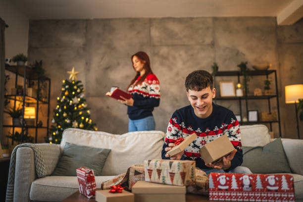 istock young man prepare Christmas gift with festive decorations at home 2176512218