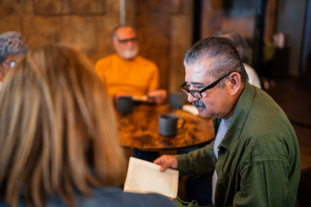 istock Senior friends on a reading book group at coffee shop 2176513616