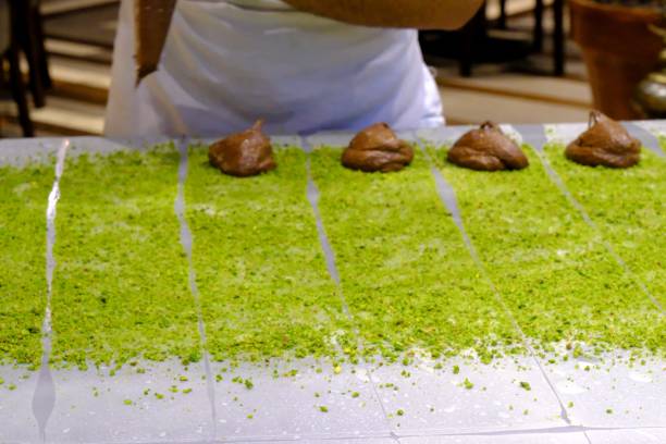istock A chef pours chocolate sauce over pistachio pastry to make chocolate katmer 2176514710