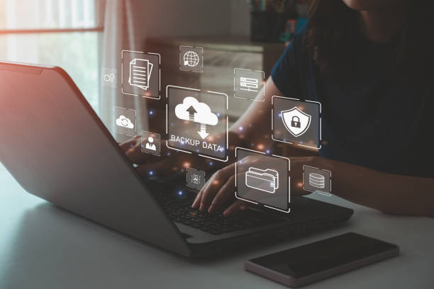 istock Businesswoman using a laptop computer to backup storage data Internet technology concept for backup online documentation database and digital file storage system or software, file access, doc sharing. 2176518640