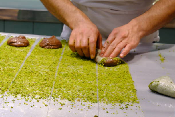 istock A dessert chef makes katmer dessert by folding pistachio and chocolate phyllo pastry. 2176523576