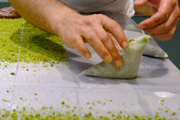 istock A dessert chef makes katmer dessert by folding pistachio and chocolate phyllo pastry. 2176523583