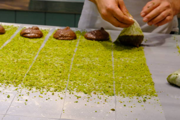 istock A dessert chef makes katmer dessert by folding pistachio and chocolate phyllo pastry. 2176523584