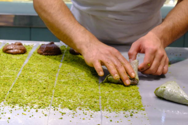 istock A dessert chef makes katmer dessert by folding pistachio and chocolate phyllo pastry. 2176523585