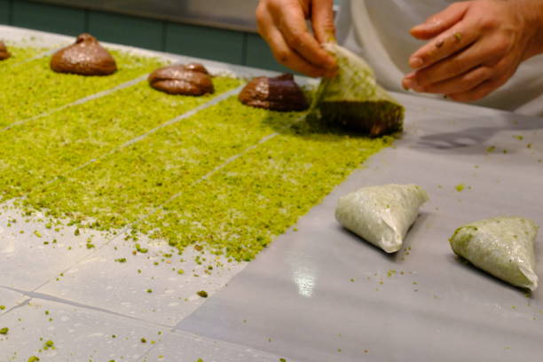 istock A dessert chef makes katmer dessert by folding pistachio and chocolate phyllo pastry. 2176523622