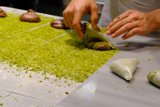 istock A dessert chef makes katmer dessert by folding pistachio and chocolate phyllo pastry. 2176523655