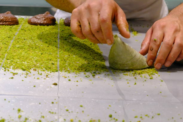 istock A dessert chef makes katmer dessert by folding pistachio and chocolate phyllo pastry. 2176523663