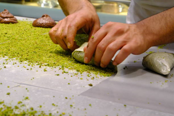 istock A dessert chef makes katmer dessert by folding pistachio and chocolate phyllo pastry. 2176523665