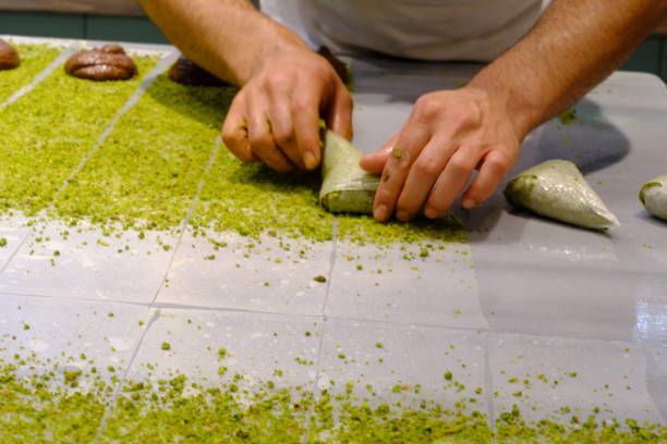 istock A dessert chef makes katmer dessert by folding pistachio and chocolate phyllo pastry. 2176523669
