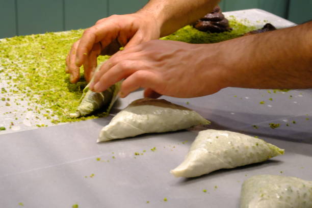 istock A dessert chef makes katmer dessert by folding pistachio and chocolate phyllo pastry. 2176523735