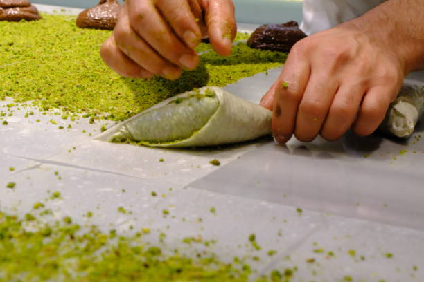 istock A dessert chef makes katmer dessert by folding pistachio and chocolate phyllo pastry. 2176523760