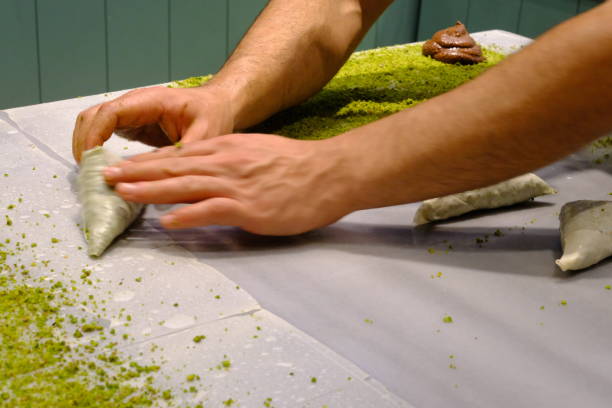 istock A dessert chef makes katmer dessert by folding pistachio and chocolate phyllo pastry. 2176523762