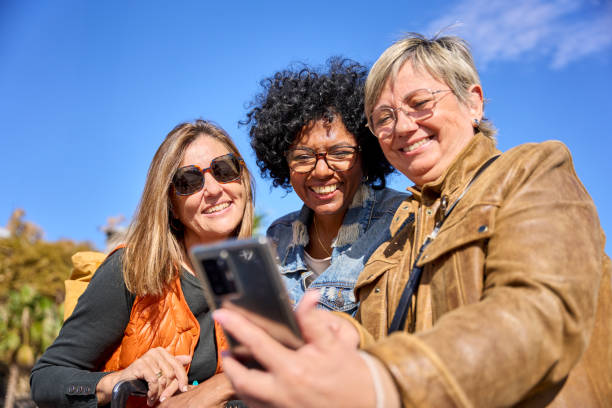 istock Group of diverse mature women smiling looking and using smartphone 2176524236