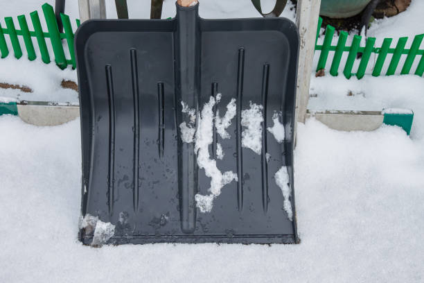 istock Black plastic snow shovel in the snow 2176544112