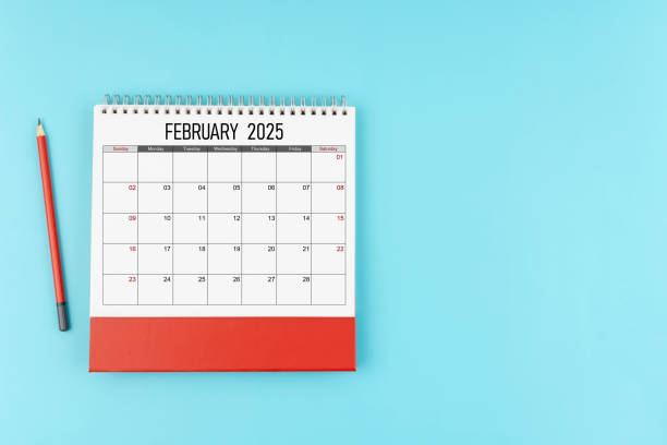 istock February desk calendar for 2025 year with pencil on blue background, Position with copy space. 2176547486