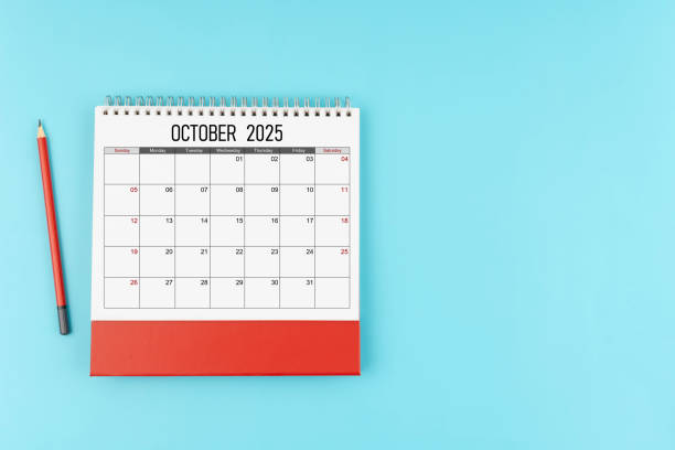 istock October desk calendar for 2025 year with pencil on blue background, Position with copy space. 2176547510