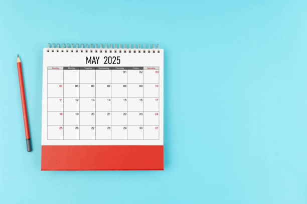 istock May desk calendar for 2025 year with pencil on blue background, Position with copy space. 2176547516