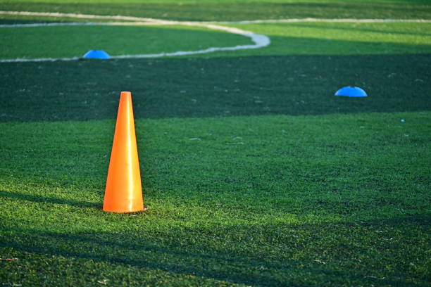 istock artificial green grass soccer field with orange training cones 2176554315