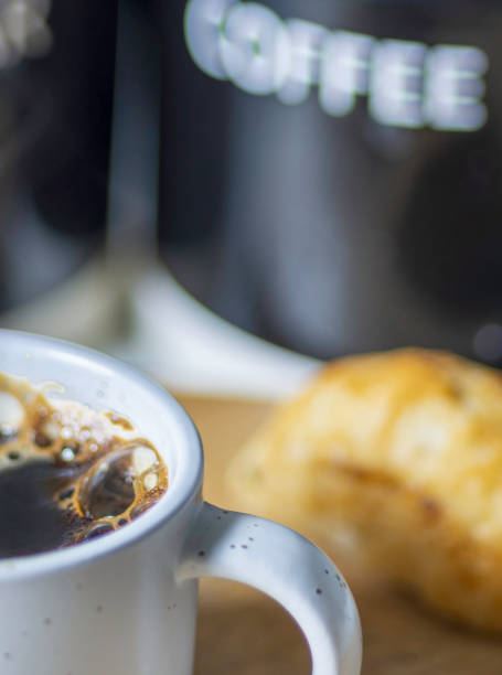 Espresso coffee,bubbly and hot in a small,white cup,in a domestic kitchen,Worcestershire,United Kingdom.